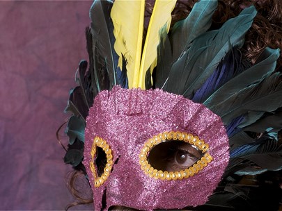 Portrait of a man in a feathered mask.