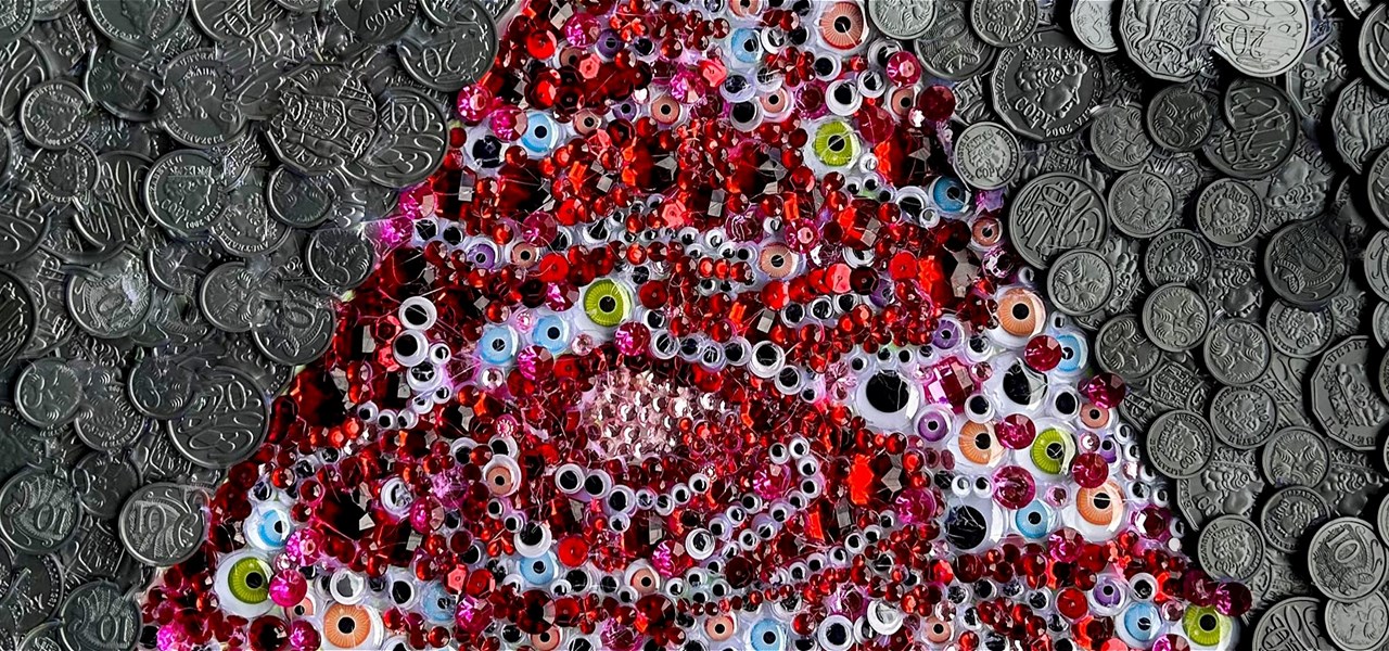 A lot of beads in the shape of a pointed hat lying on a bed of silver coins