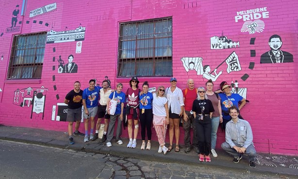 Midsumma Staff standing in front of a Melbourne Pride (2022) mural