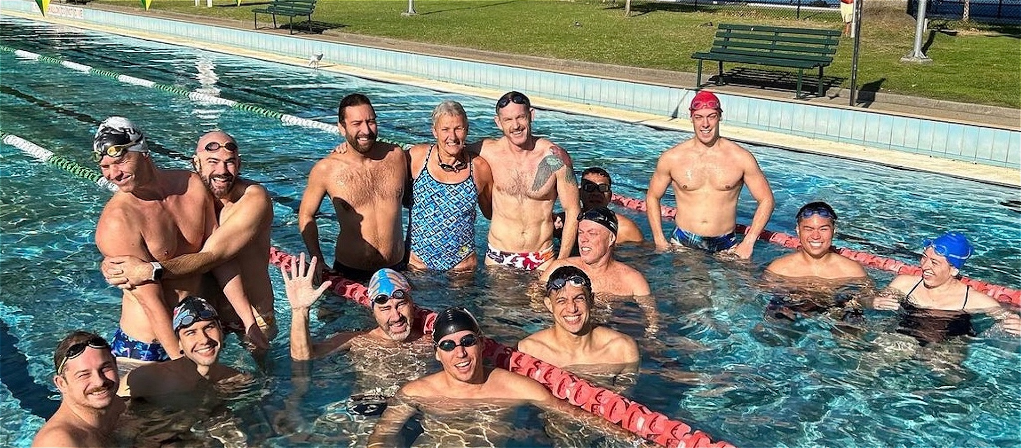 Glamourhead Sharks swimmers standing in a pool at a training session - posing for the camera