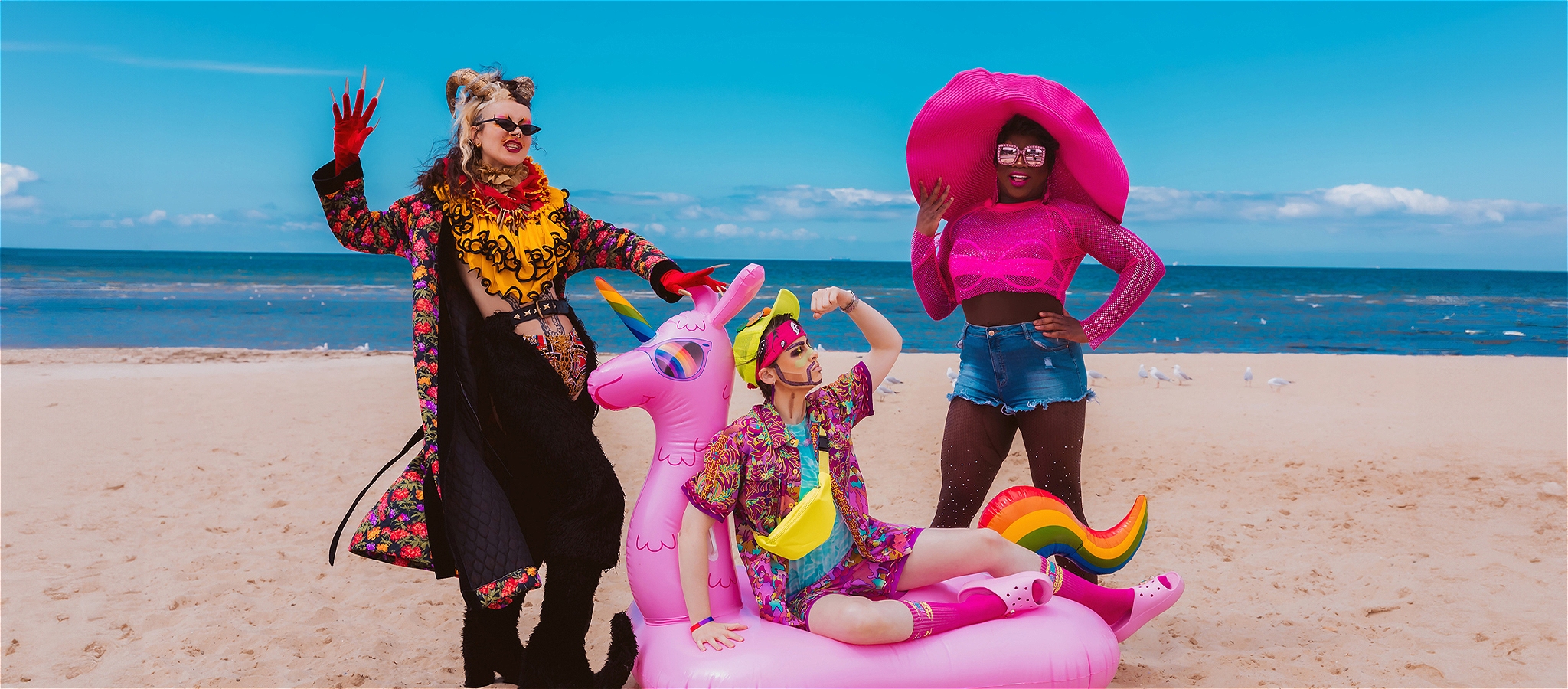 Three colourful drag performers on the sunny Altona beach front.